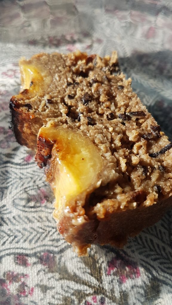 Miso sea weed banana bread sliced on a transparent plate with pattern of table cloth